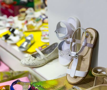 Lots of kids shoes on the shelf in the shopの写真素材