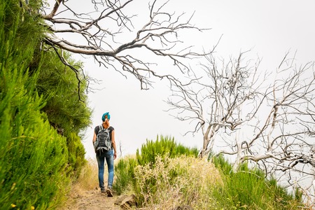 Woman hiking in obscure cloudy mountains, Portugal, Madeira