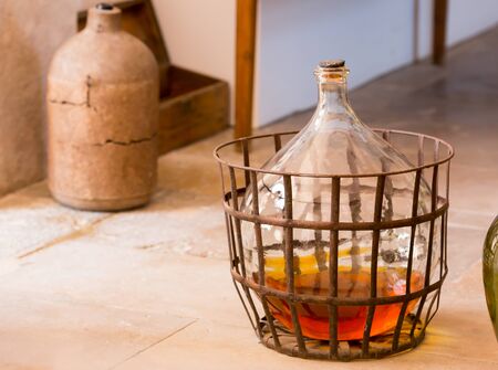 Carboy with some beverage stands on the floor in the kitchenの写真素材