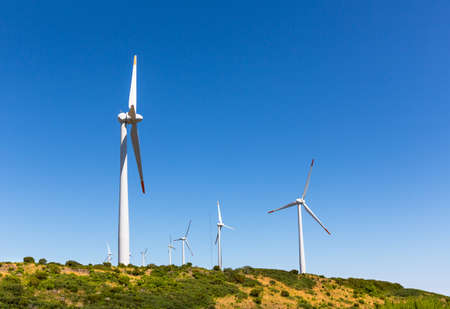 Windmills against clear blue sky