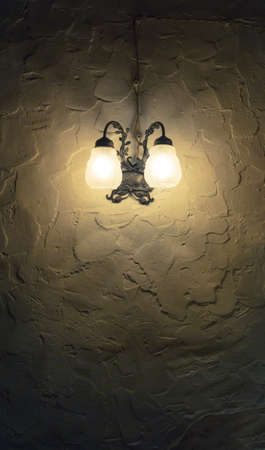 Lantern on the wall in dark investmentの写真素材
