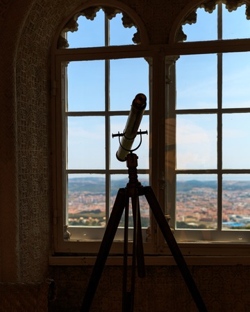 Telescope stands in the room near the windowの写真素材