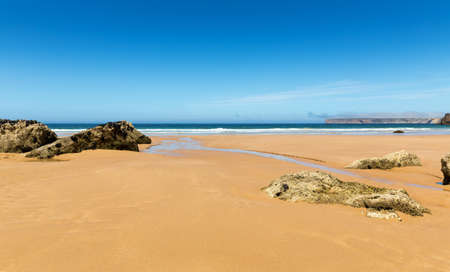 Coastline with waves of the sea on the sandy summer beach, Portugal