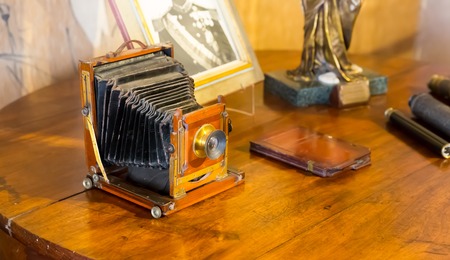 Retro photocamera on the wooden table close upの写真素材