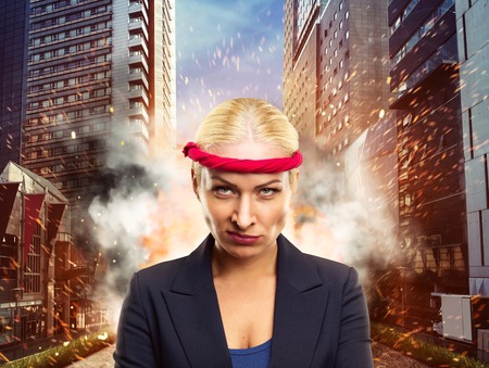 Furious businesswoman with a red bandage in the cityの写真素材