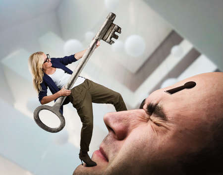 Young woman with key on the man's face with keyhole