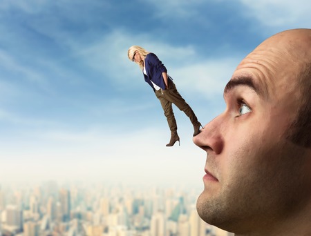 Confident analyst is walking on the man's faceの写真素材