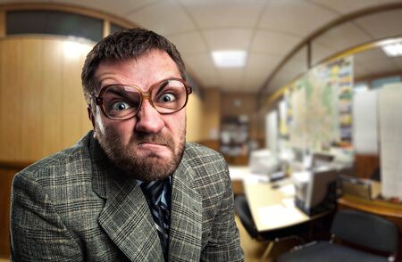 Angry businessman in glasses looking at you