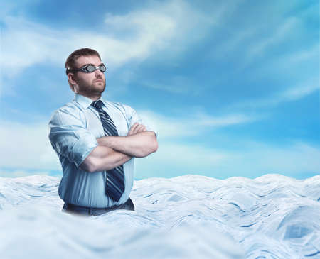 Businessman swimmer with crossed hands in the sea of papersの写真素材