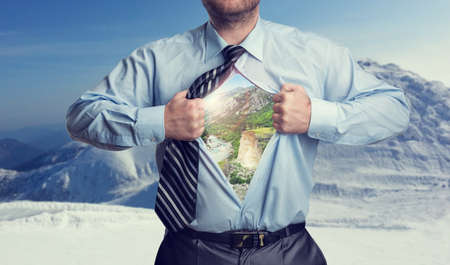 Businessman with mountains inside his shirtの写真素材