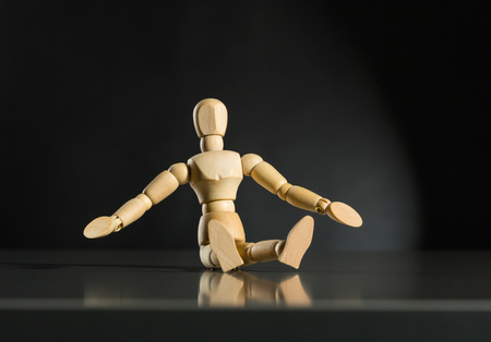 Human wood manikin in meditatingの写真素材