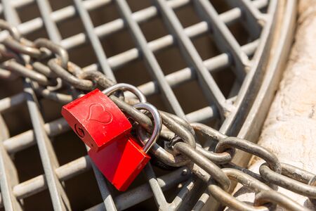 Two red love locks on the chain close upの写真素材