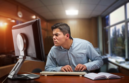 Young businessman working hard in the office with computerの写真素材