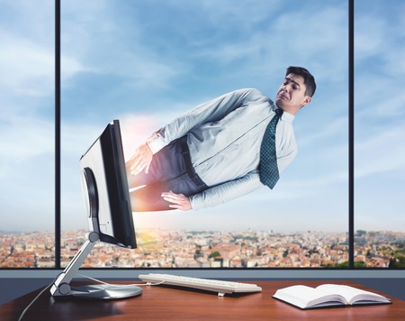 Man is being pulling inside the computer in the office