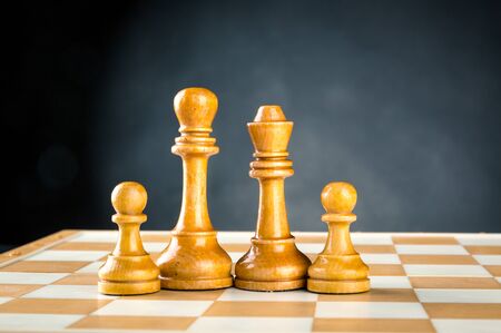 Wooden chess figures standing on the boardの写真素材