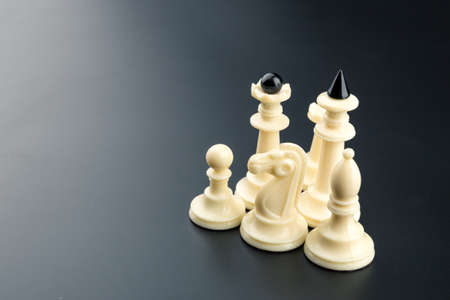 White chess figures on the table over blackの写真素材