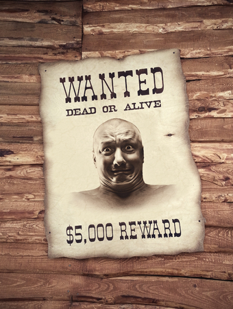 Criminal on the wanted list on the wooden wallの写真素材