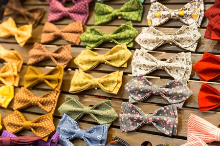 Multicolored vintage bow-ties with flowers on the boardの写真素材