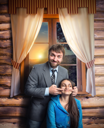 Businessman making a woman smile near the houseの写真素材