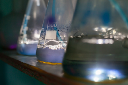 Three flasks with chemical reagents