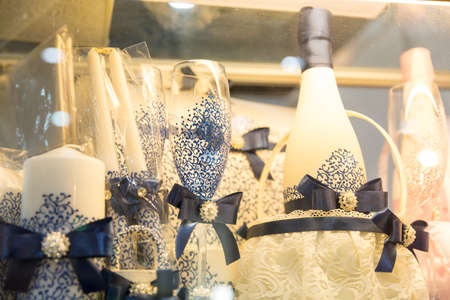 Beautiful blue festive set of glasses, candles and wine with ribbonsの写真素材