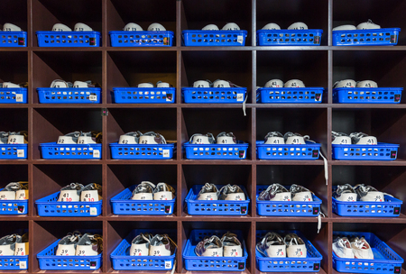 Many pairs of bowling shoes on the shelfの写真素材