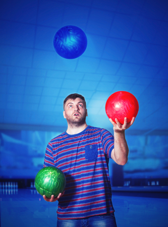Man juggling with bowling ballsの写真素材