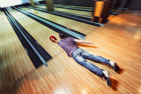 Man lying on the floor in bowlingの写真素材