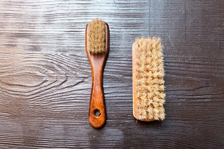 Two barber's brushes on the wooden table