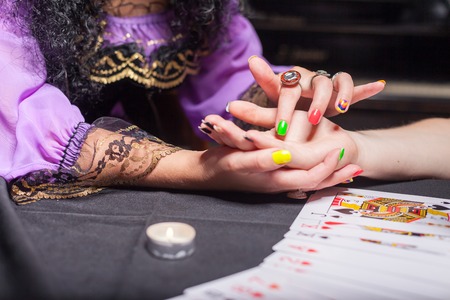 Close up of sorceress reading somebody's handの写真素材