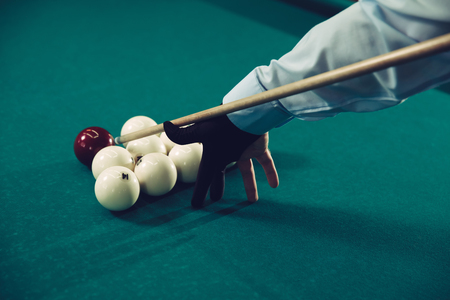 Close up of man preparing to shoot playing billiardの写真素材