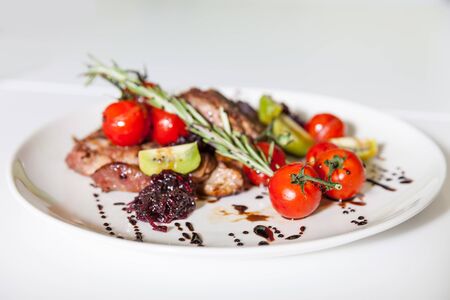 Tasty meat dish with vegetables stands on the tableの写真素材