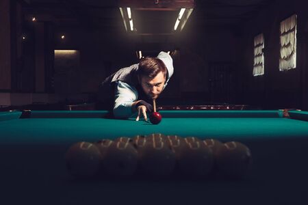 Young man preparing to shoot balls in triangle