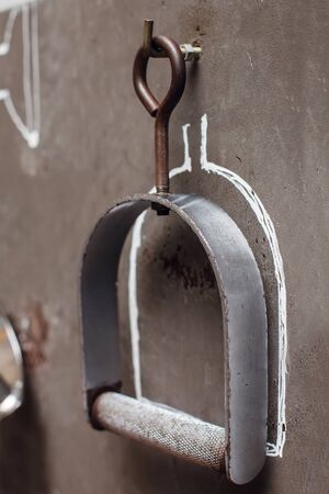 Steel sport machine equipment on the hangers on the wall