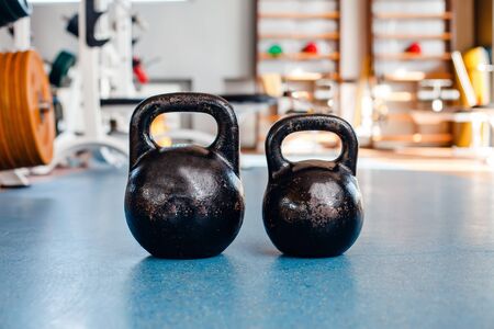 Kettle bells on the floor in the gymの写真素材