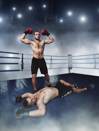 Fighter wins the strike on the ring. Boxing ring on the background. Boxer sents the opponent to the knockout.の写真素材