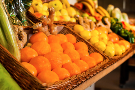 Fresh fruits and vegetables on the counter against the background of a market.の写真素材