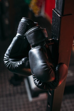 Boxing gloves on the rack in the gymの写真素材
