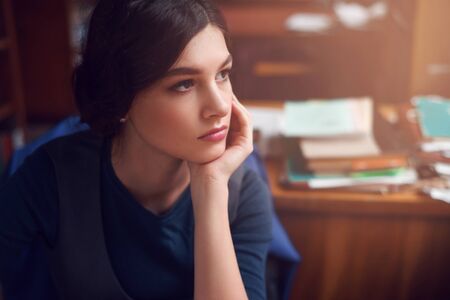 Portrait of clever young woman thinking alone. Knowledge, education, thinking and studying concept.の写真素材