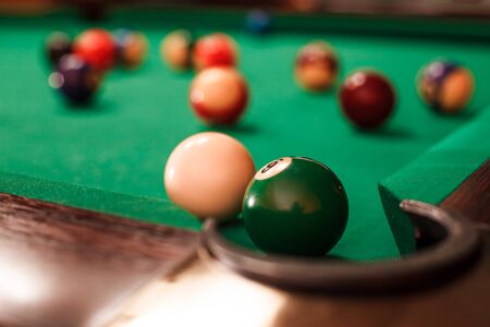 Above view on two billiard balls opposite to a pocket. Angle of the billiard table.