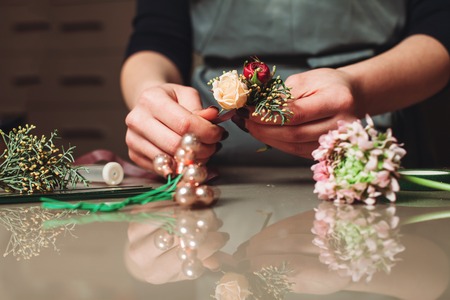 Female florist creating bouquet decoration closeupの写真素材