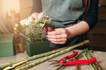 Florist at work closeup: woman creating decorative bouquet of flowers.の写真素材