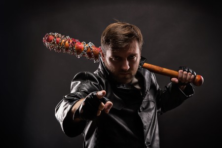 Killer with bloody bat on black background.の写真素材