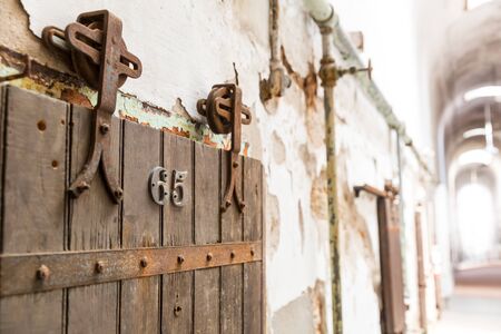 Wooden door of old prison cell closeup.の写真素材