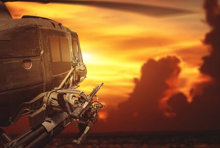 Military helicopter flying on sunset background.
