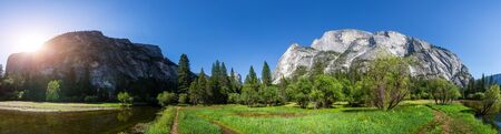 River surrounded by rocky mountains panoramic viewの写真素材