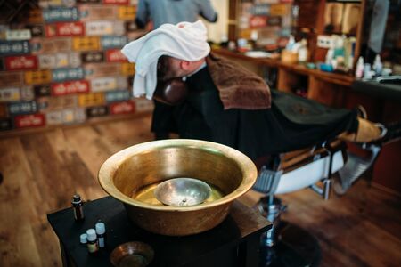 Basin and shaving tools on the table at barbershopの写真素材