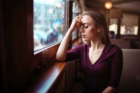 Woman waiting in coffee shopの写真素材