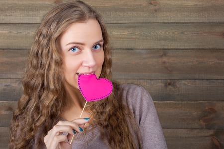 Cute woman with funny heart on a stickの写真素材