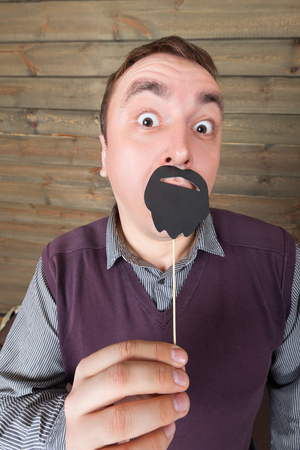 Male with funny sunglasses and beard on a stickの写真素材